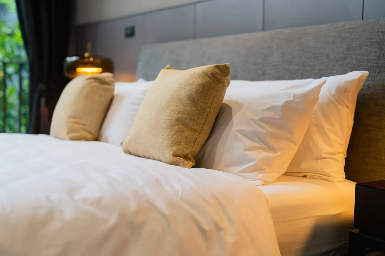 Freshly made bed with crisp white linens